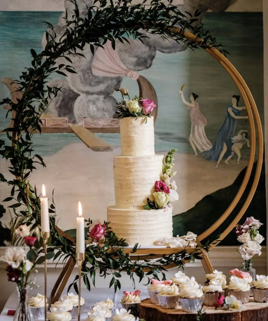 Wedding Day Celebration - Wedding Event Styling Ireland Beautiful wedding cake display with floral hoop and cupcakes at Irish wedding celebration